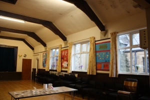 Hall with noticeboards, curtains and chairs